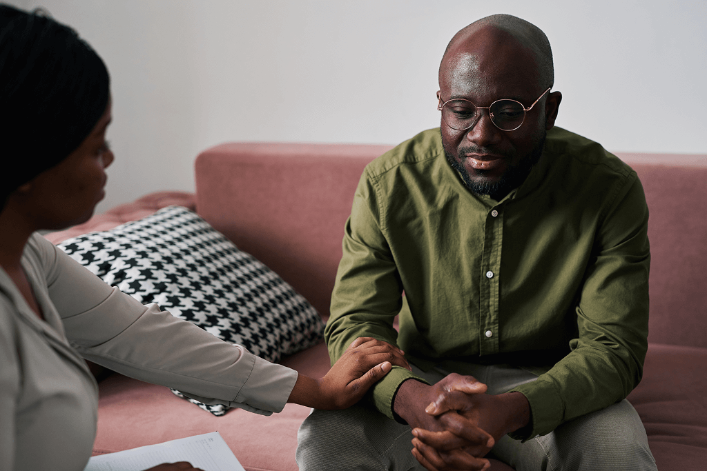 young-man-sitting-on-couch-while-counseloR